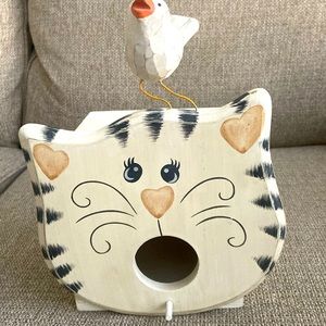 Wooden cat birdhouse, the orange and white cat show with a bird on its head.